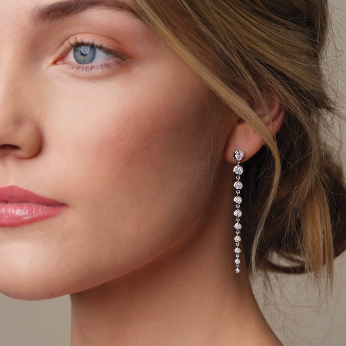 Model wearing 2 CTW Lab Diamond Drop Dangle Bezel Set Graduated Solid Gold Earrings