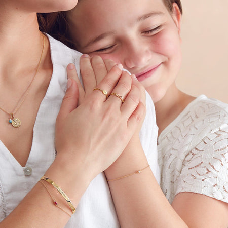 Child wearing our Youth Adjustable Faux Pearl Solid 14K Yellow Gold Bracelet