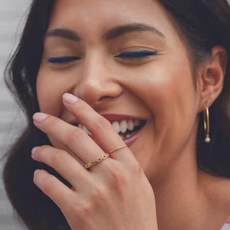 Model wearing 1 MM Stacking Ring 14K Yellow Gold by Vintage Magnality
