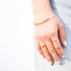 Model wearing Diamond Stackable Chevron Ring in 14K Yellow Gold along with our Gold Bangle and Gypsy Signet Ring