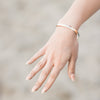 Model wearing 6mm half round bangle in 14K Yellow Gold Storyteller by Vintage Magnality