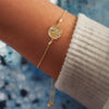 Aphrodite Coin Cable Chain Bolo Style Bracelet in 14K Yellow Gold on Model's Wrist