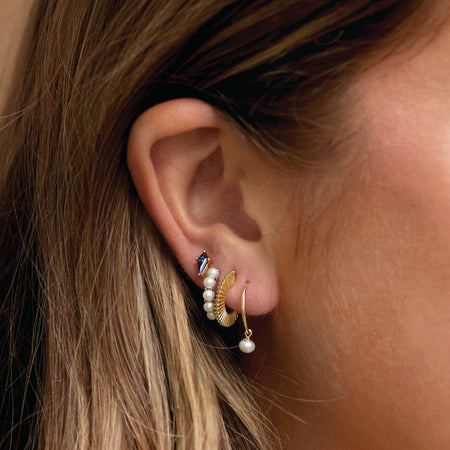 Model's curated ear features our Poppin Pearl Wear Everyday® Huggie Hoop Earrings Solid 14K Yellow Gold 