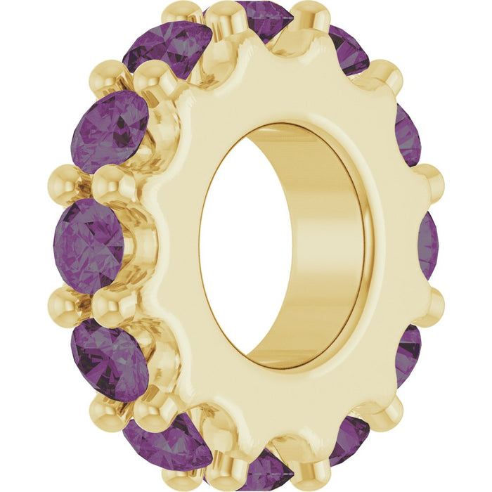 Gold charm with purple gemstones on a white background