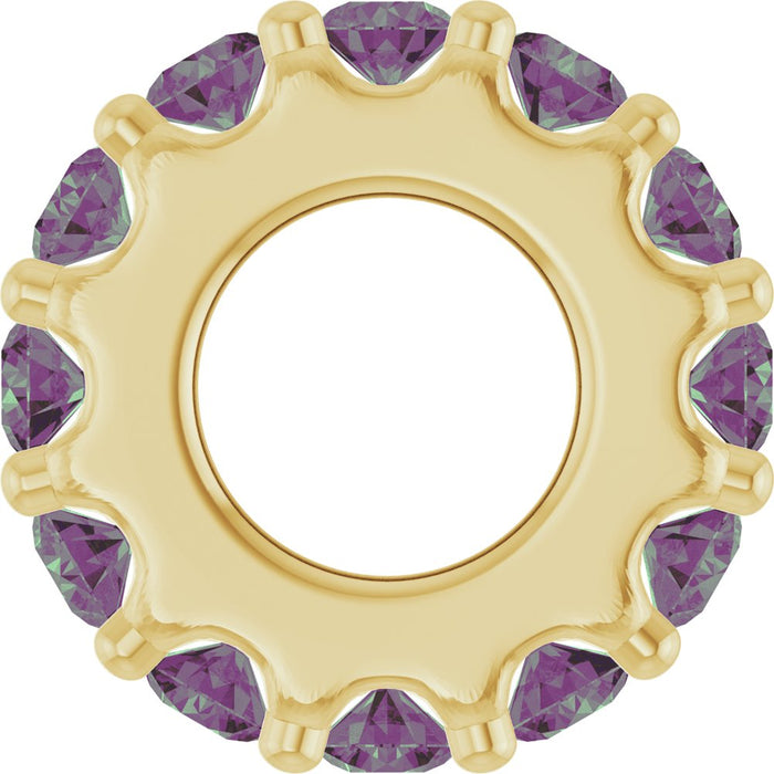 Gold charm with purple gemstones on a white background