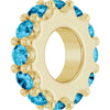 Gold charm with blue gemstones on a white background