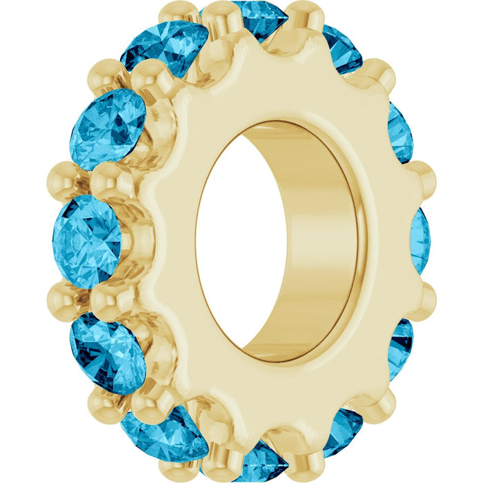Gold charm with blue gemstones on a white background