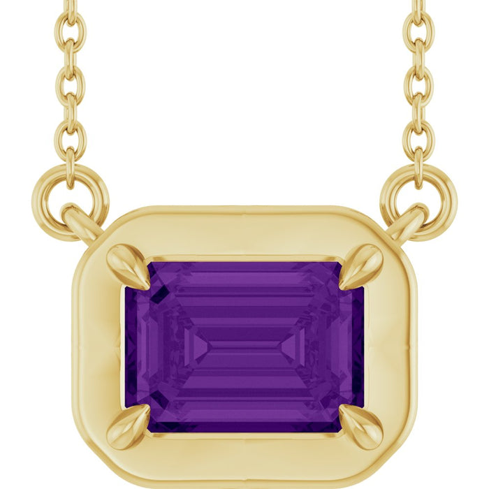 Gold necklace with a purple gemstone on a white background