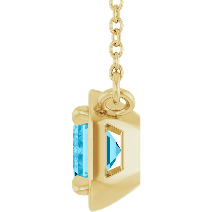 Gold pendant with a blue gemstone on a white background