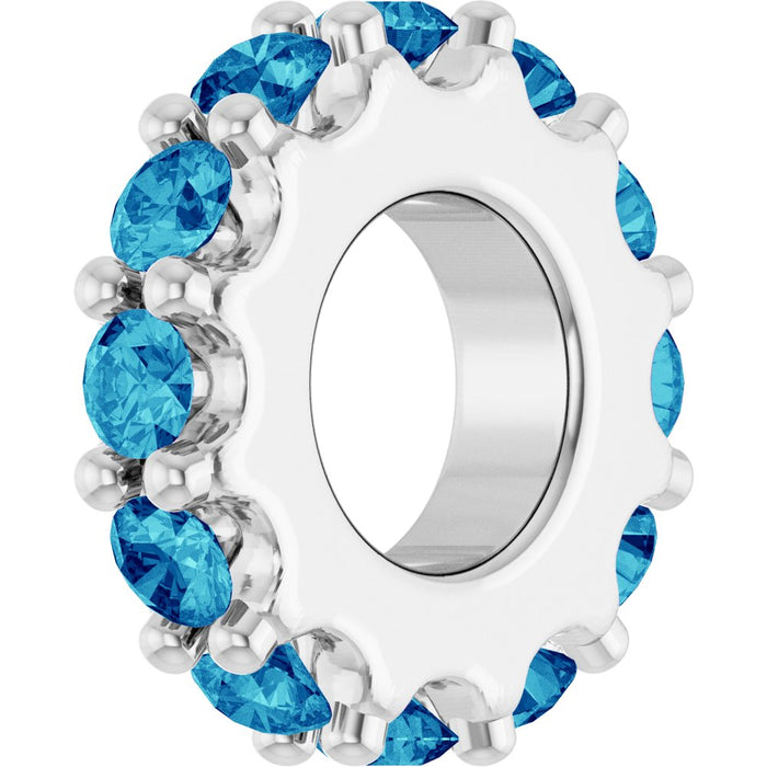 White gold charm with ocean blue gemstones on a white background