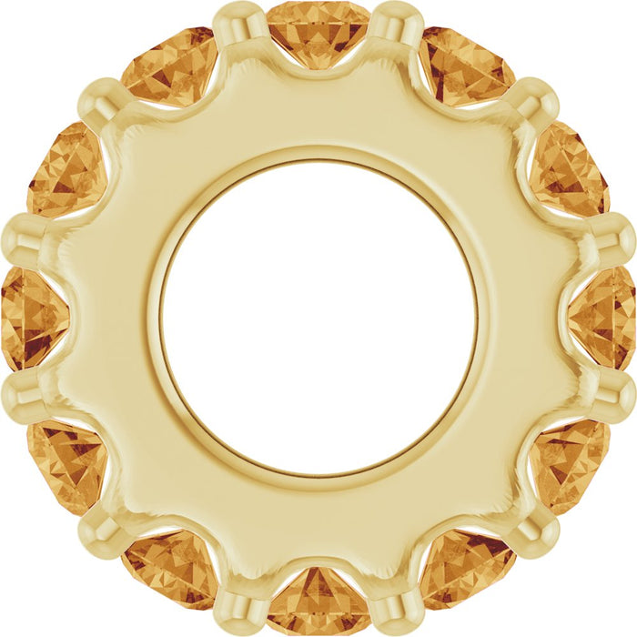 Gold charm with citrine gemstones on a white background