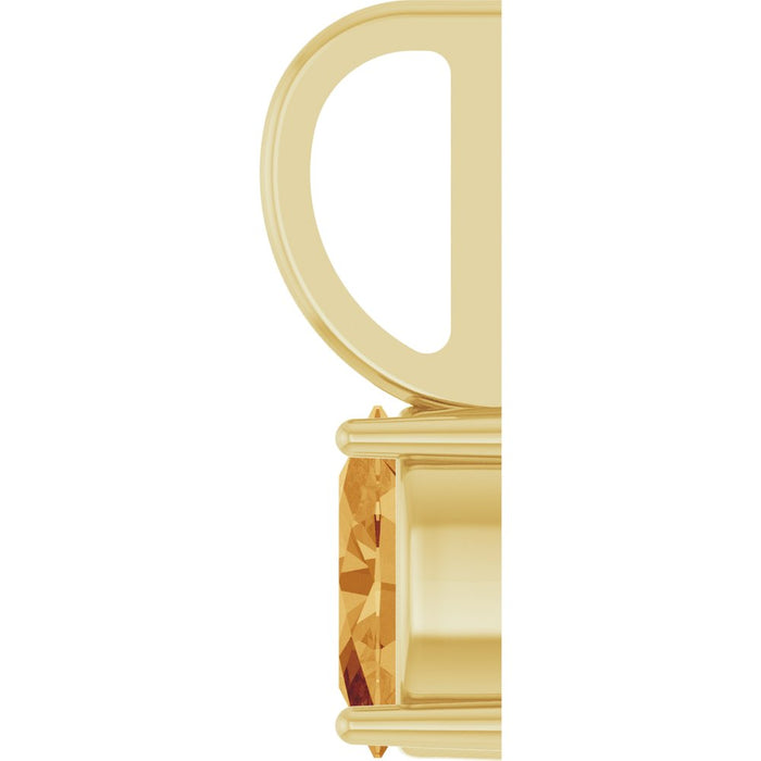 Gold pendant charm with a citrine gemstone on white background 