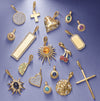 Collection of various gold pendant charms on a purple background