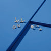Various diamond earring jackets on blue background 