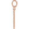 Rose gold dog tag charm with diamonds on a white background