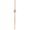 Side view rose gold graduation diamond necklace with a simple pendant on a white background