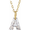 Gold necklace with a floating diamond a initial on a white background