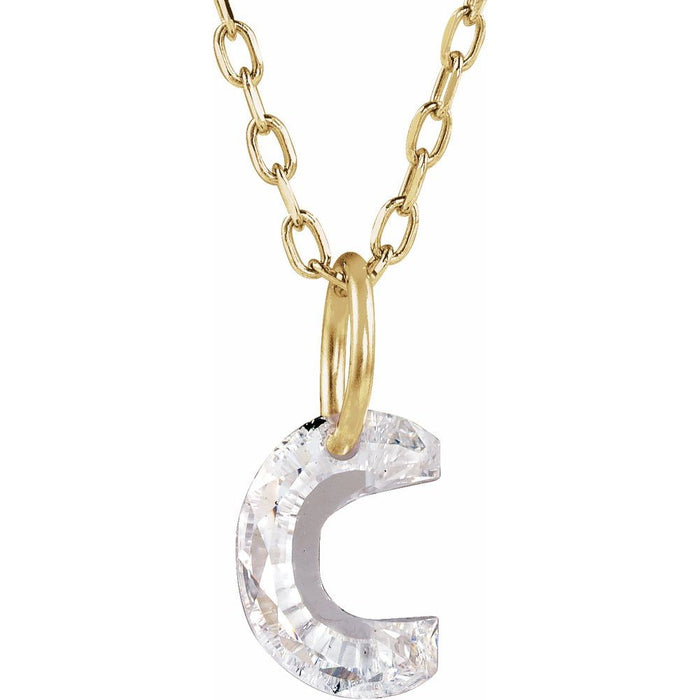 Gold necklace with a floating diamond c initial on a white background