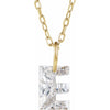 Gold necklace with a floating diamond e initial on a white background
