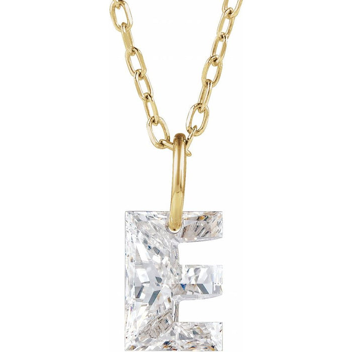 Gold necklace with a floating diamond e initial on a white background
