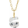 Gold necklace with a floating diamond g initial on a white background