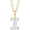 Gold necklace with a floating diamond i initial on a white background