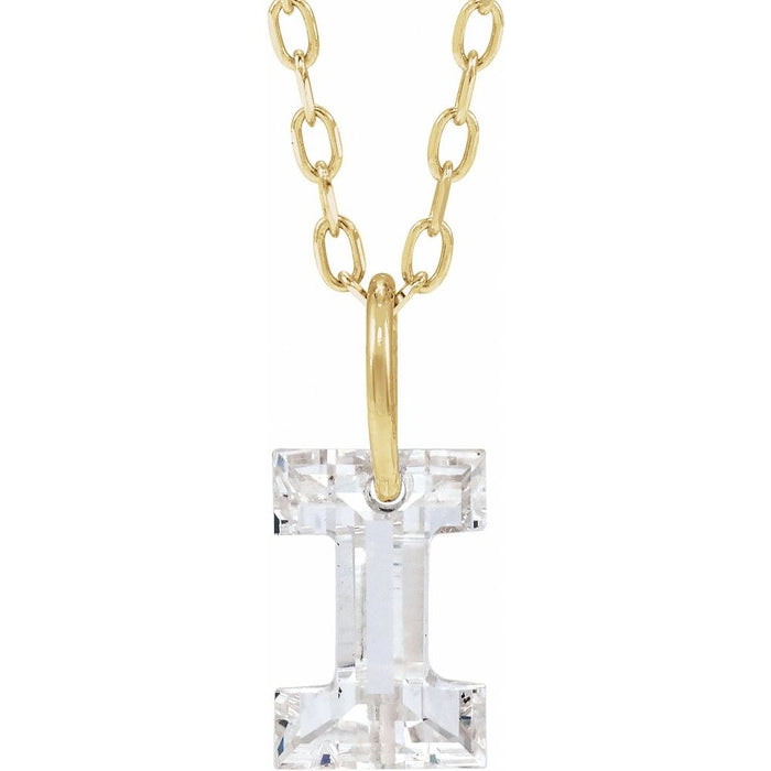 Gold necklace with a floating diamond i initial on a white background