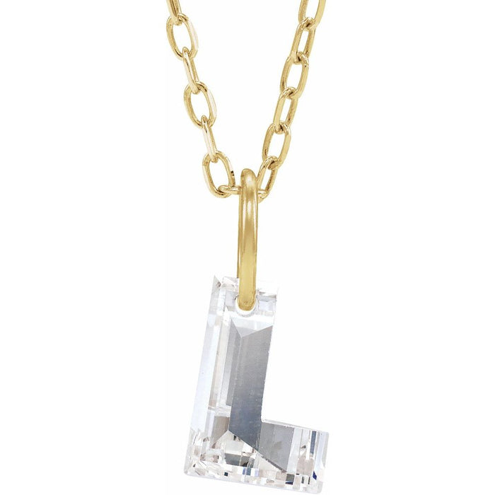 Gold necklace with a floating diamond L initial on a white background