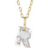 Gold necklace with a floating diamond r initial on a white background