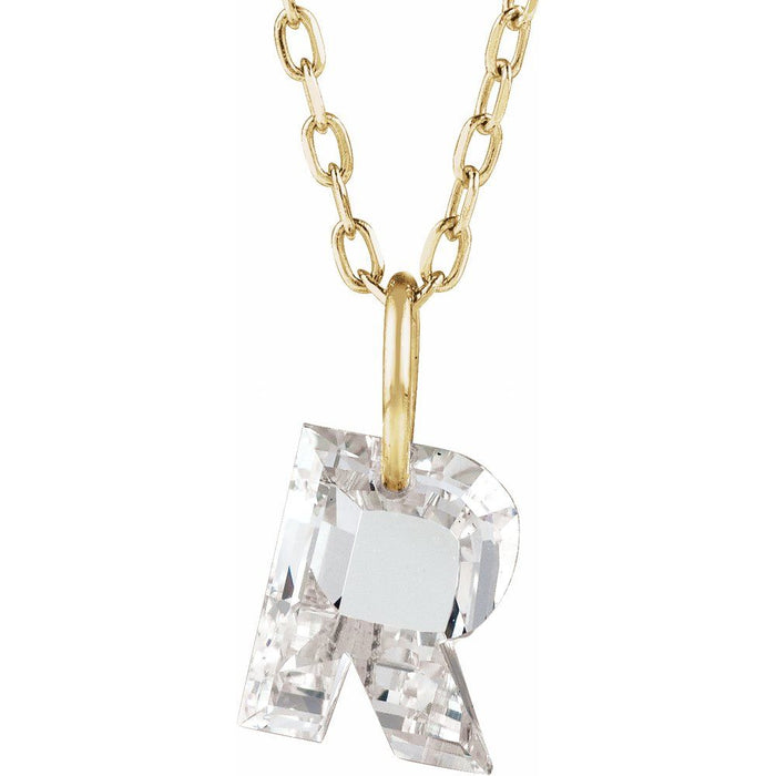 Gold necklace with a floating diamond r initial on a white background