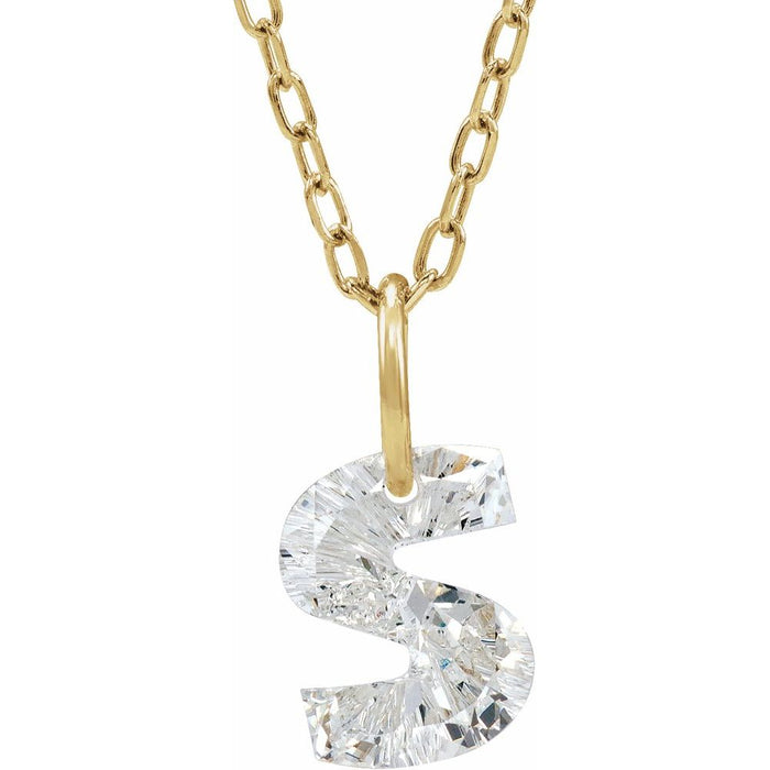 Gold necklace with a floating diamond s initial on a white background