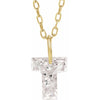 Gold necklace with a floating diamond t initial on a white background