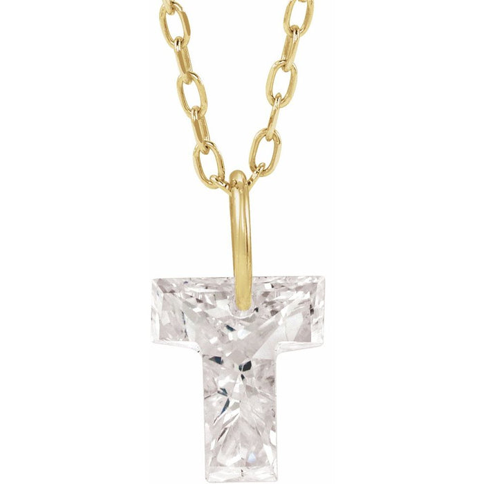 Gold necklace with a floating diamond t initial on a white background