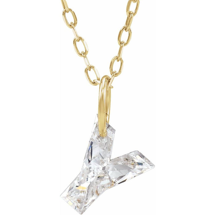 Gold necklace with a floating diamond y initial pendant on a white background