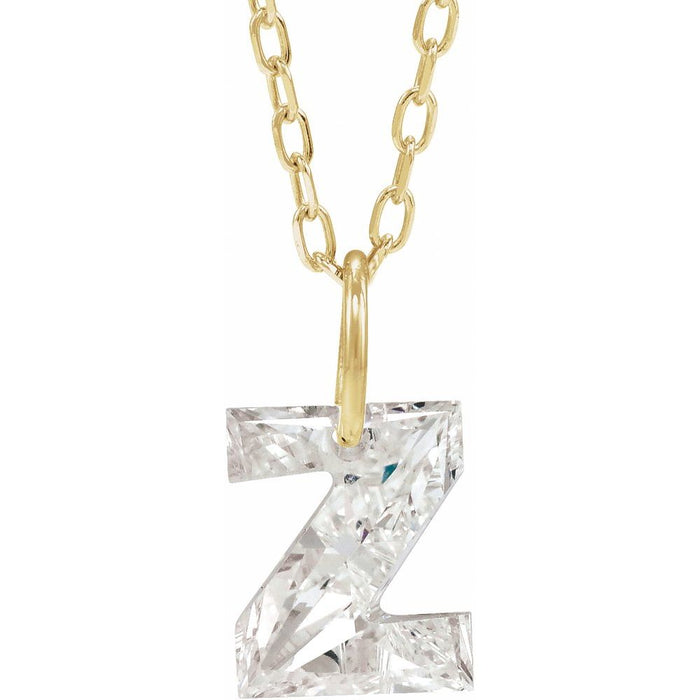 Gold necklace with a floating diamond z initial pendant on a white background