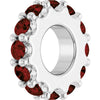 White gold charm with dark red gemstones on a white background