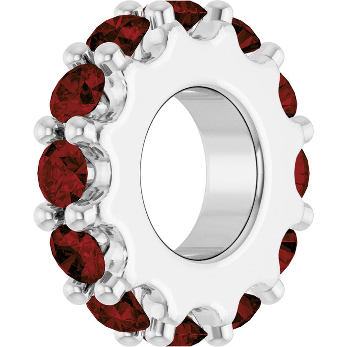 White gold charm with dark red gemstones on a white background