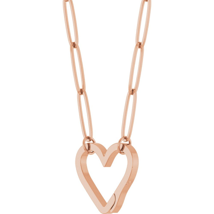 A rose gold paperclip chain necklace featuring a large, open heart-shaped bail pendant suspended from elongated oval links slightly turned on a plain white background.