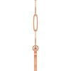 A rose gold paperclip chain necklace featuring a distinctive elongated oval link, with a heart shaped bail, with a side view shown against a plain white background.