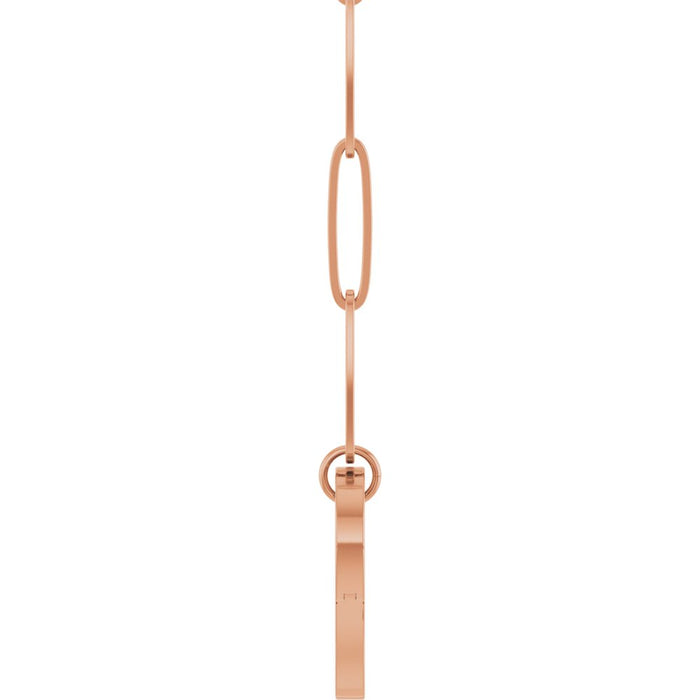 A rose gold paperclip chain necklace featuring a distinctive elongated oval link, with a heart shaped bail, with a side view shown against a plain white background.