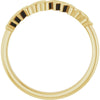 Gold ring with a textured band on a white background