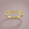 Gold script ring with 'mama' on a pink background