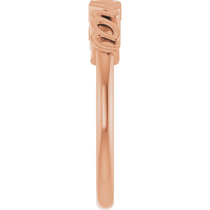 Rose gold ring with 'mama' engraving on a white background