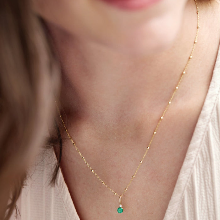 Model wearing May Birthstone Emerald and Diamond Charm Pendant