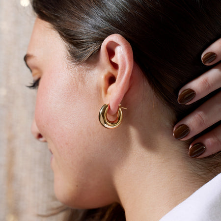 Model wearing our Puffy 20 MM Hinged Hollow Hoop Earrings in 14K Yellow Gold 