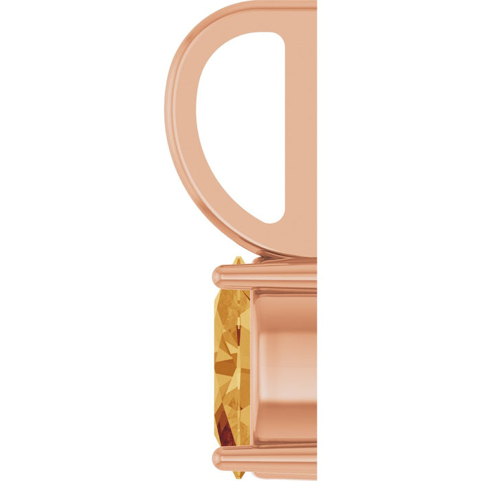 Close-up of a rose gold pendant setting with a faceted citrine gemstone, shown against a plain white background.
