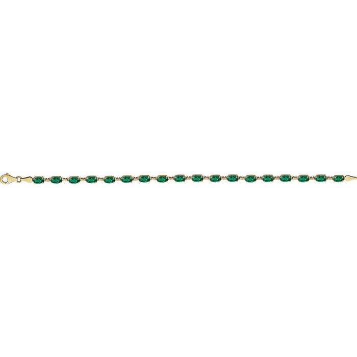A yellow gold tennis bracelet featuring a row of oval-cut green emerald-cut gemstones, shown against a plain white background.