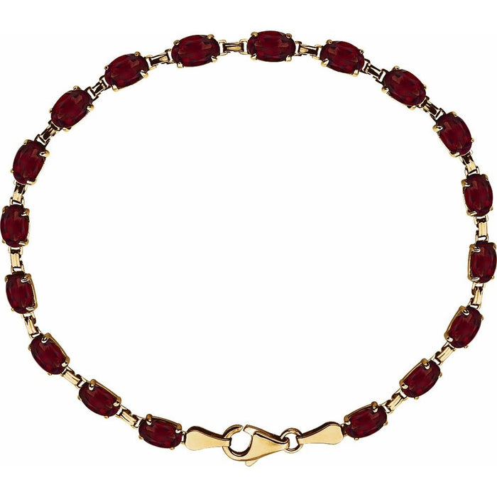 A gold tennis bracelet featuring oval-cut deep red garnet gemstones, arranged in a circular shape on a solid white background.