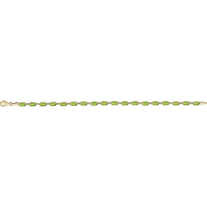 A yellow gold tennis bracelet featuring a row of oval-cut green peridot gemstones, displayed horizontally against a solid white background.