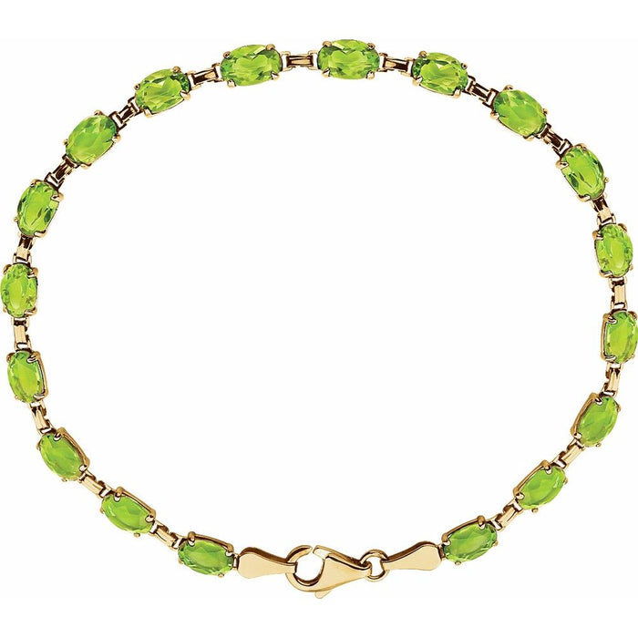 A gold tennis bracelet featuring a row of oval-cut green peridot gemstones, displayed on a clean white background.
